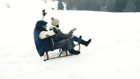 Beautiful senior couple on sledge having fun, winter day. - Powered by Shutterstock - Get 15% off with code: PIKWIZARD15