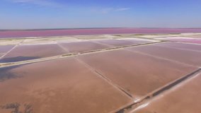 Salt evaporation ponds at red salty lake, aerial video / Salt production in salt ponds, aerial video 