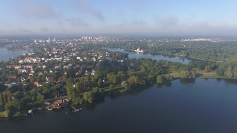 drone flight high over urban area and beautiful landscape, aerial of Potsdam, Berlin, Brandenburg, Germany - lakes in romantic sunlight 