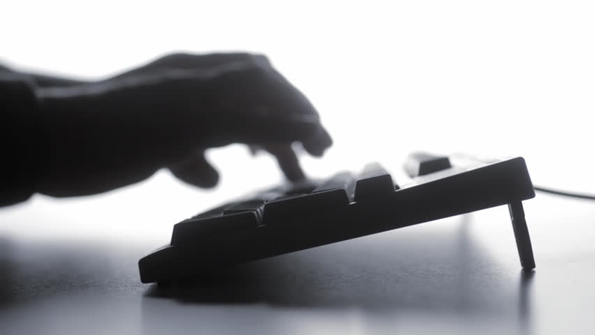 Blurry silhouette of man typing