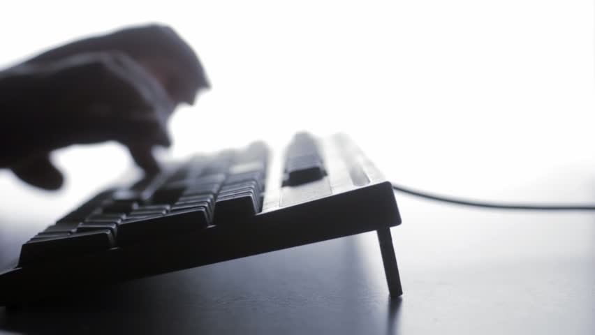 Blurry silhouette of man typing, tracking