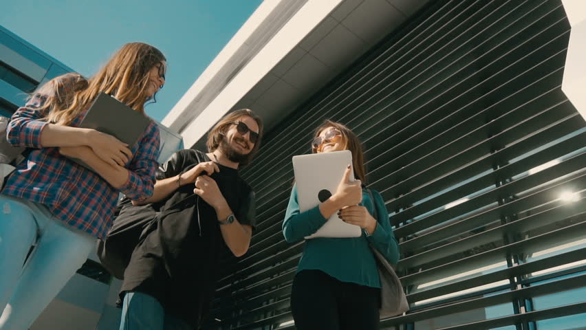 Up view of group of students, walk before modern building, have a pleasant talk, sunny day steady 120FPS slowmotion Royalty-Free Stock Footage #31418065