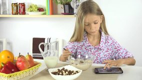 Child Playing Tablet, Eating Cereals with Milk at Breakfast, Girl in Kitchen 4K