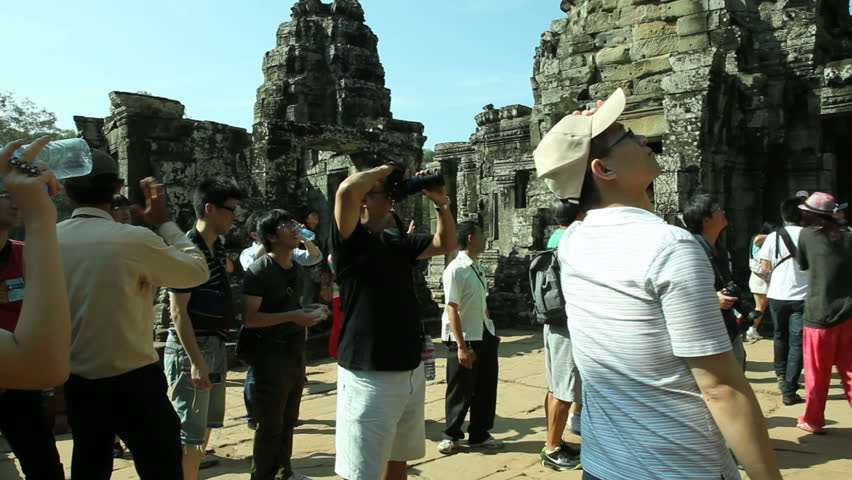 BANGKOK, DECEMBER 9, 2012: A group of tourists is visiting Bayon Temple in