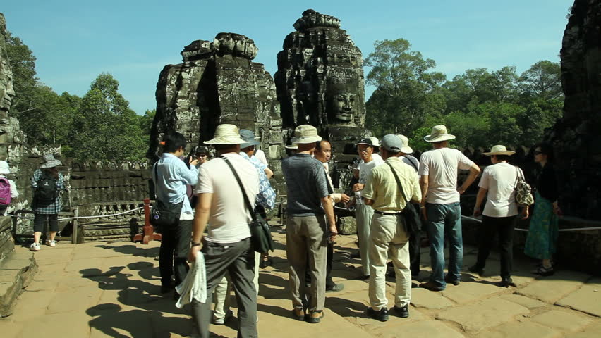 BANGKOK, DECEMBER 9, 2012: A group of tourists is visiting Bayon Temple in