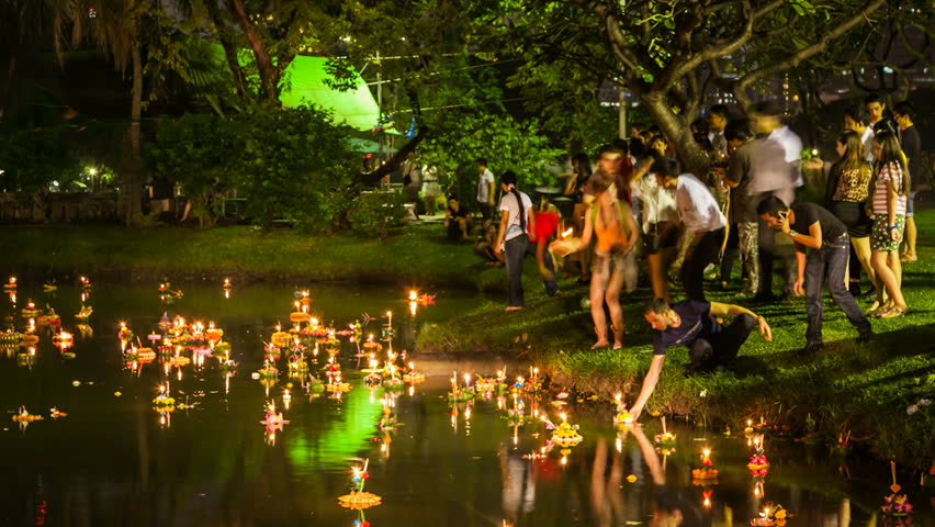 BANGKOK, NOVEMBER 29, 2012: Timelapse of People lighting Krathongs during the