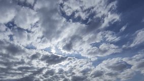 Fluffy clouds time lapse in blue clear skies, White sunny weather over blue sky. Time lapse clip of white puffy cloud over, Fantastic nice day time. Full HD, 1920x1080.