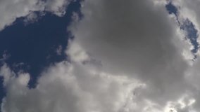 Fluffy, puffy light white clouds time lapse, fast motion in sunny day, Loop of beautiful weather. White clear blue skies motion background. Running across. Full HD, 1920x1080p.