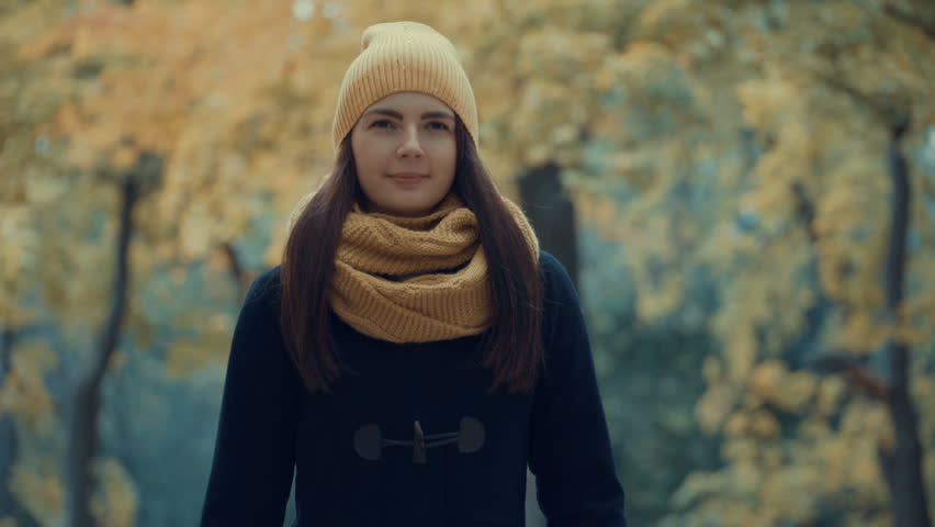 young girl walks in the park in autumn. Footage steadicam shot