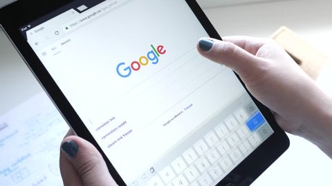 Girl making a search in Google on her Tablet