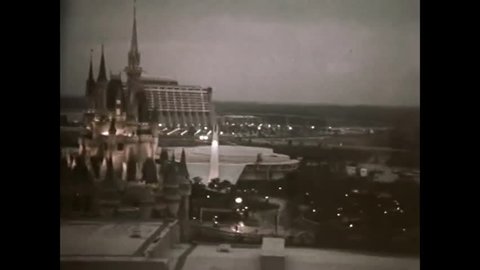 CIRCA 1972 - The construction of the Walt Disney World Resort Hotel is shown as well as a family riding a monorail to their room and standing on the balcony, in Florida.