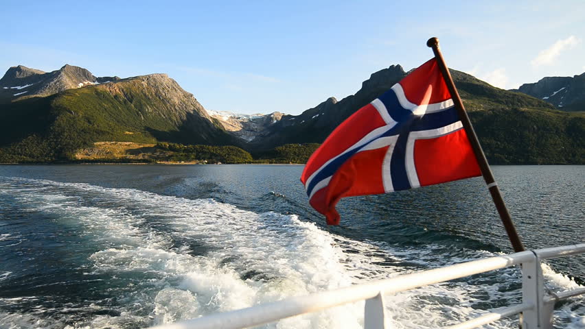 Norways flag on the ferry trough Arhaugfjorden to the Svartisen glacier, Holandsfjord, Norway, Scandinavia, Europe. Royalty-Free Stock Footage #31443856