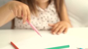 Cropped Close up view of young asian woman sitting by the table with her daughter and draws together