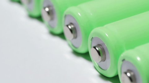 Rechargeable lithium-ion batteries are rolling. Conservation and accumulation of green electricity. Ecological concept. close-up, smooth movement.