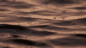 Super slow motion of water surface. Contemplative shot of water moving slowly