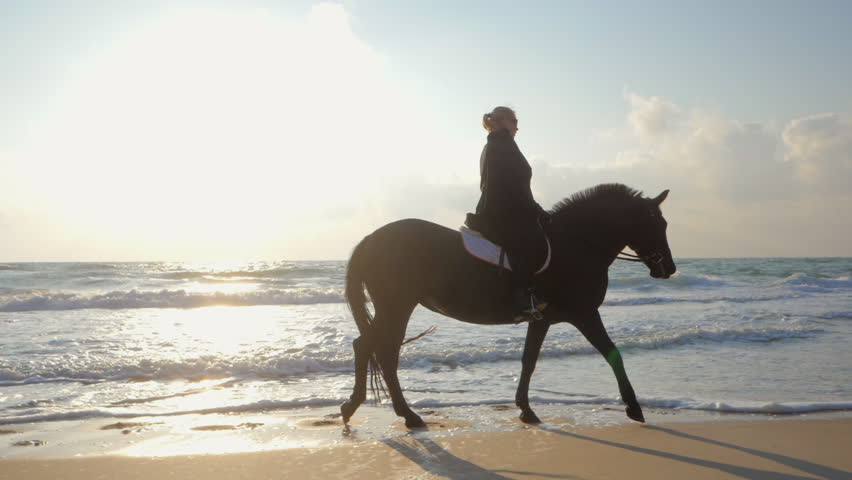 Golden-Haired beauty riding at the beach