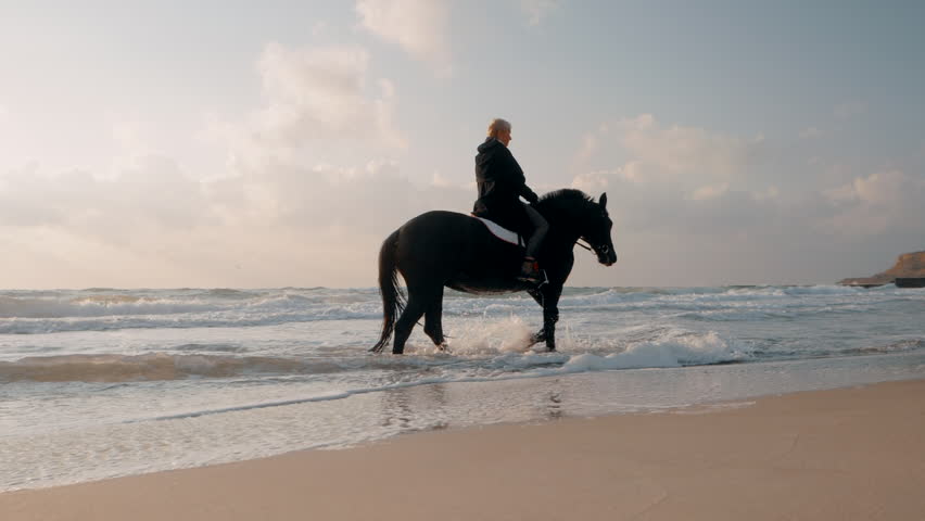 Golden-Haired beauty riding at the beach