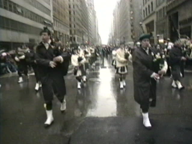 NEW YORK, USA - MARCH 17: Irish descendants march on 5th Avenue and play Irish music during rainy St. Patrick's Day parade, New York, USA March 17, 1995 | Shutterstock HD Video #3145549