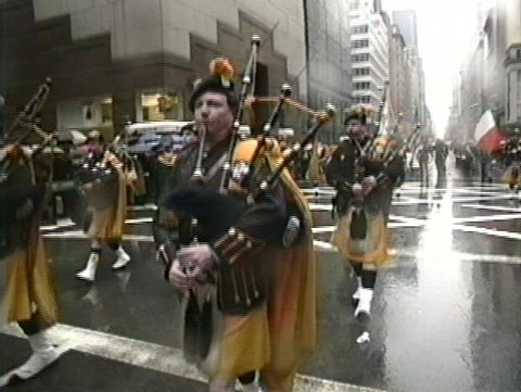 NEW YORK, USA - MARCH 17: Irish descendants march on 5th Avenue and play Irish music during rainy St. Patrick's Day parade, New York, USA March 17, 1995 Editorial Stock Video
