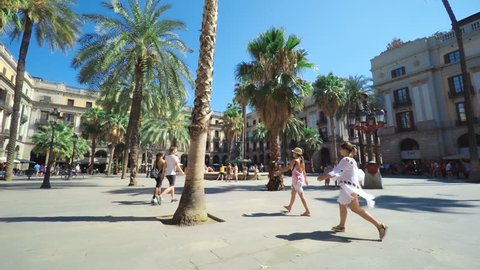 SPAIN BARCELONA JULY 2017: Barcelona Plaza Real, famous square with fountain and palms, tourists walking around beautiful historic buildings.