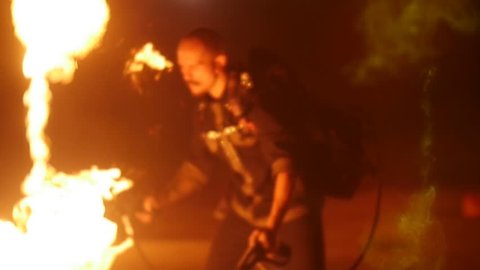 circus actor with a flamethrower fires. Action in slowmotion