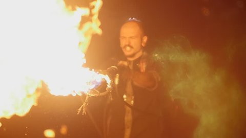 the stuntman releases a circle from the flamethrower. Action in slowmotion