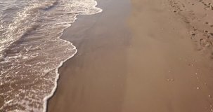 Aerial view of waves crashing on the beach at sunset, Video Shot in Sabaudia, a beautiful beach on the west coast of central Italy.