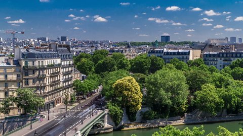Panorama of Paris timelapse with Bastille column and traffic on road. View from observation deck of Arab World Institute (Institut du Monde Arabe) building. Top aerial view. Green trees, Seine river