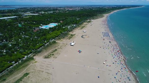 Italy, the beach of the Adriatic sea. Rest on the sea near Venice. Aerial FPV drone flights.