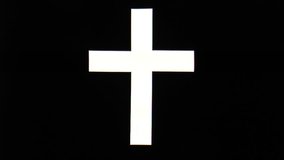 The video shows white christian cross on black background
