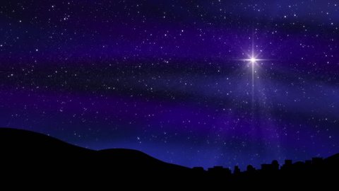 Seamless loop features the Bethlehem Christmas Nativity star with hundreds of twinkling stars in a colorful night sky silhouetting the town of Bethlehem. Light rays and sparkling particles.