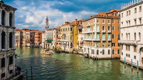 VENICE, ITALY - APRIL 7: Gondolas and boats pass by on the Grand Canal near Rialto in time lapse on April 7, 2012 in Venice, Italy. Venice is a UNESCO World Heritage Site and a popular tourist destination.