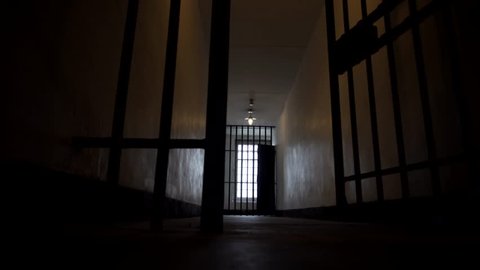 Prison Bars Close Shut in a Dark, Depressing and Lonely Looking Jail in 4K. Secure Penitentiary Cell.