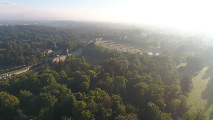 4K Aerial over baroque palace Sanssouci in Berlin Potsdam Germany, drone view over green garden and trees in warm sunset light, high quality scene 