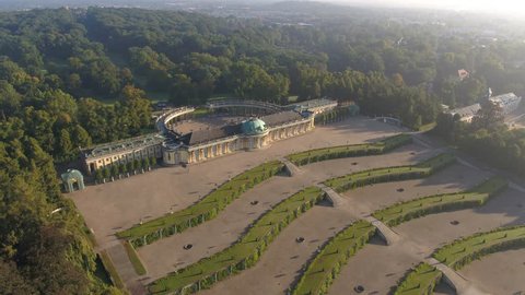 4K Aerial of famous castle Sanssouci in Berlin, drone flight over green garden, warm sunset light, König Ludwig der 14.  