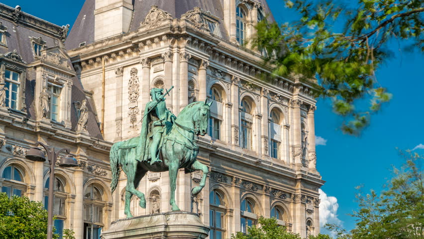 The bronze statue of Etienne Marcel proudly standing beside the Hotel de Ville timelapse, Paris, France. Traffic on the street. Blue sky at summer day