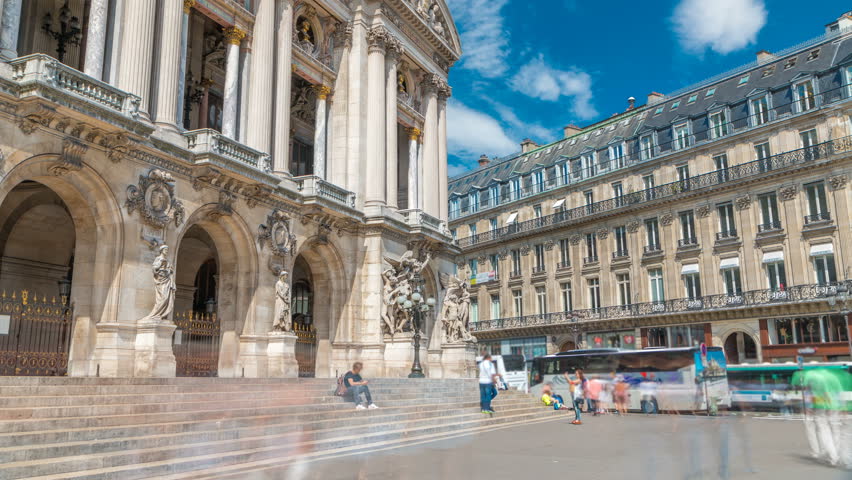 Palais or Opera Garnier The National Academy of Music timelapse in Paris, France. People walking around and traffic on the street. It is a 1979-seat opera house, which was built from 1861 to 1875 for