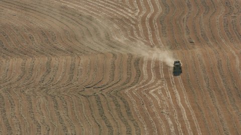 Salem, Oregon circa-2017, Aerial view of combine in field. Shot with Cineflex and RED Epic-W Helium.