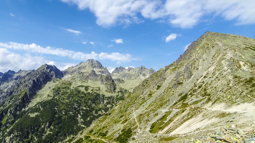 Picturesque summer view of High Tatras mountains near Popradske Pleso, Slovakia. Trekking to Sedlo pod Ostrvou (1966m). Mount Ostrva (1984m) on the right. Mount Kopky (2354m) in the center. Time Lapse