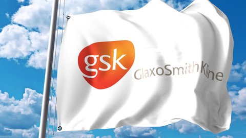 Waving flag with GlaxoSmithKline GSK logo against clouds and sky. 4K editorial animation