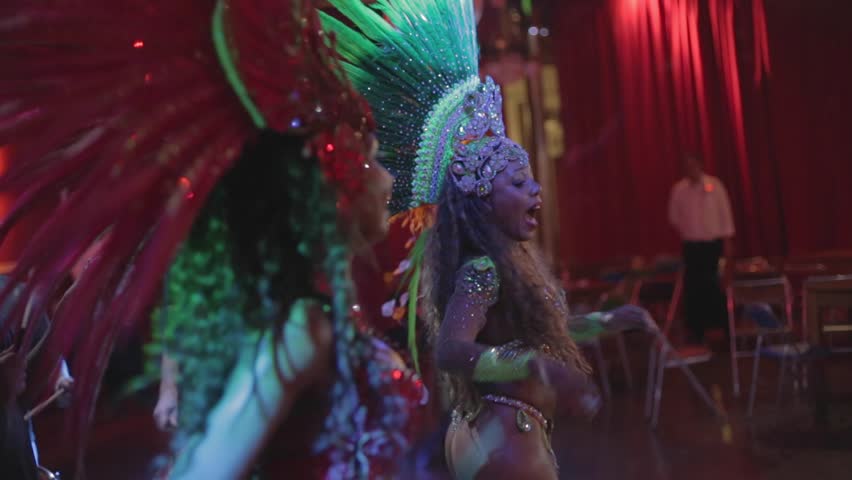 Pair of Brazilian samba dancers dancing side by side and clapping