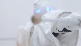 Modern robot toy and an assistant at the exhibition of modern robotics and advanced technologies. - Powered by Shutterstock - Get 15% off with code: PIKWIZARD15