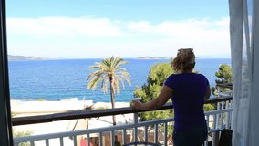 Woman watching sea view from balcony