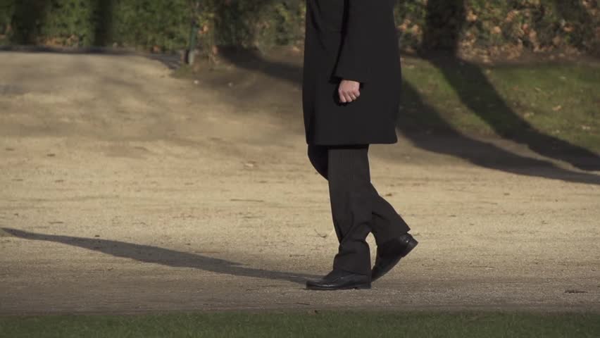 Slow motion anonymous man walking in the park