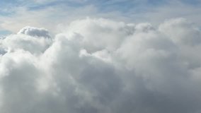 Time lapse clouds in blue sky, fast moving, sunny weather motion, Seamless Loopable, Towering Cumulus Billows, Loop features puffy white fly over a deep blue skies, Full HD background, 1920x1080.
