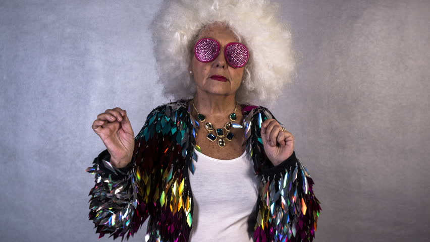 An amazing grandma disco dancer, older lady partying in a disco setting Shu...