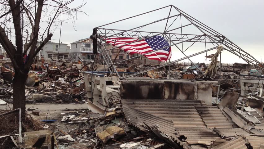 BREEZY POINT, QUEENS, NY-December 2, 2012: Video clip of wreckage and debris from homes destroyed by devastating fire during Hurricane Sandy.  American flag is draped in background of devastation.
