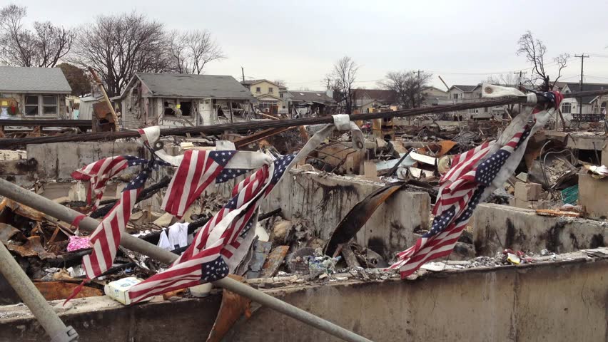 BREEZY POINT, QUEENS, NY - December 2, 2012: Video clip of wreckage and debris from fire from Hurricane Sandy.  Draped American flags are tied to cable to show strength of country and community.