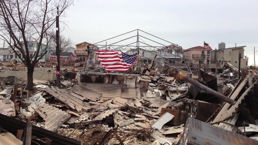 BREEZY POINT, QUEENS, NY-December 2, 2012: Video clip of wreckage and debris from homes destroyed by devastating fire during Hurricane Sandy.  American flag is draped in background of fallen homes.