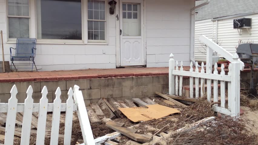 BREEZY POINT, QUEENS, NY-December 2, 2012: Damaged home from waves and storm surge due to Hurricane Sandy. Video pans across demolished front yard and tilts up to reveal home.